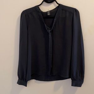Black blouse with rhinestone neck tie.